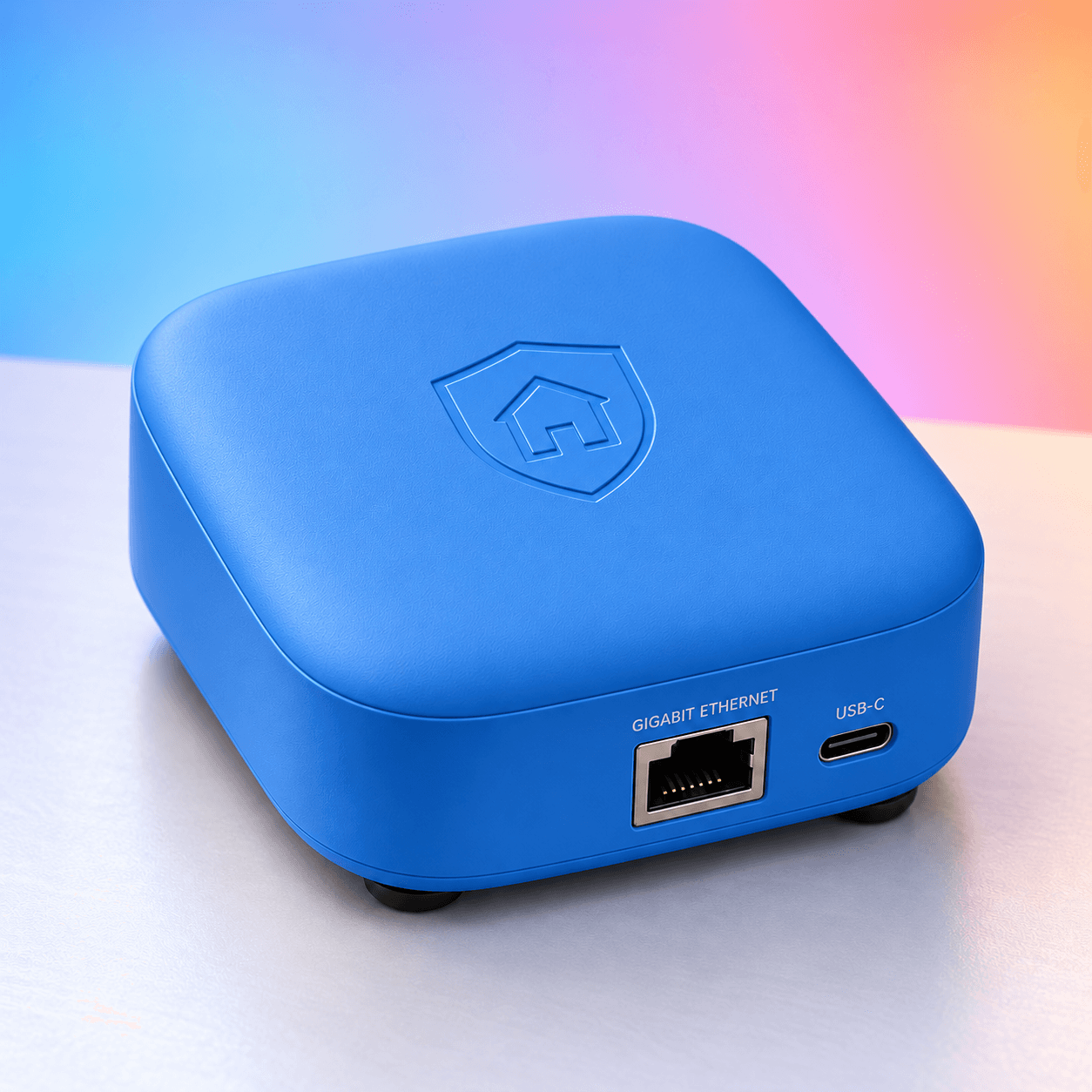Blue HomeVault VPN appliance with recessed house shield logo and rear Ethernet and USB-C connections